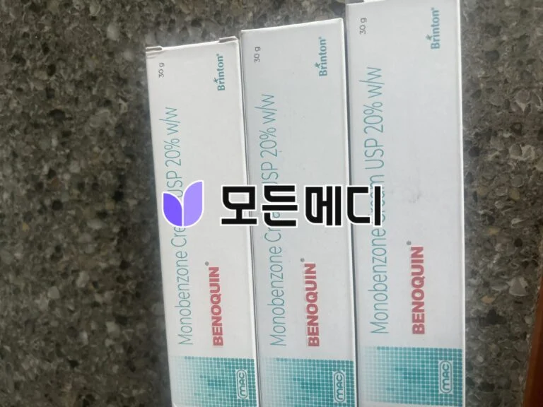 Three white medicine boxes on a dark speckled countertop with blue vertical text and a purple logo.
